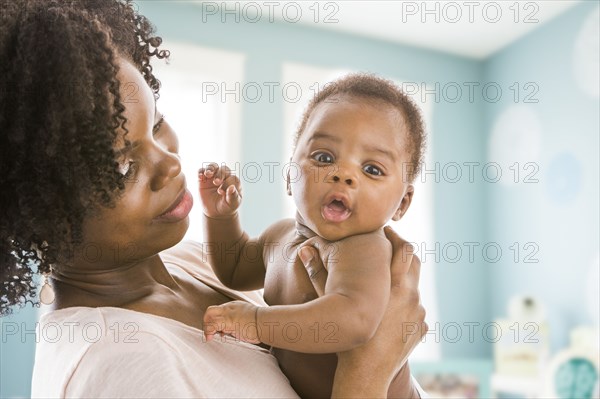 Black mother holding baby son