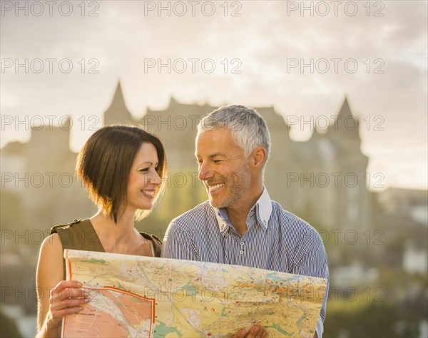 Caucasian couple reading map