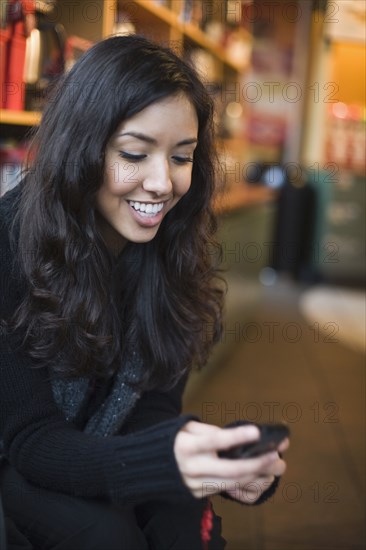 Middle Eastern woman looking at cell phone