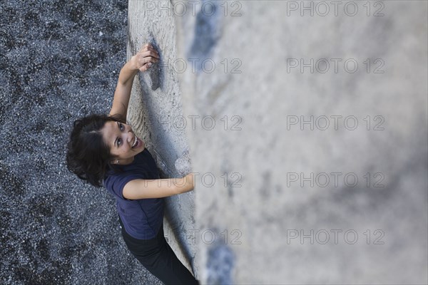 Filipino woman rock climbing