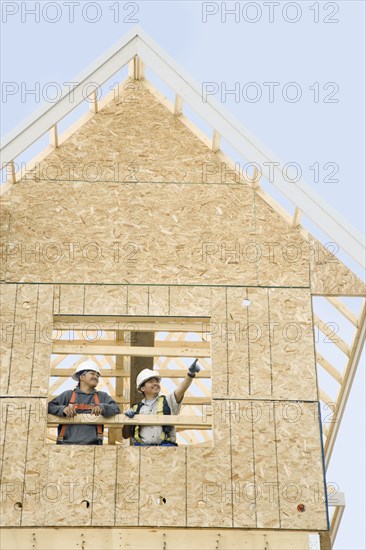 Construction workers building house