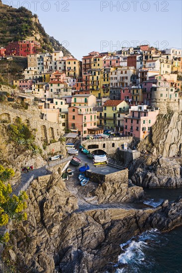 Houses on cliff face near ocean