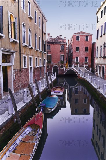 Boats moored on tranquil canal