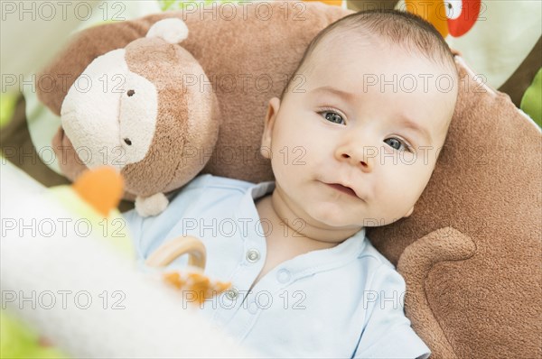 Mixed race baby laying on pillow