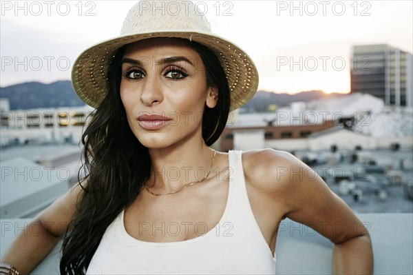 Middle Eastern woman on urban rooftop