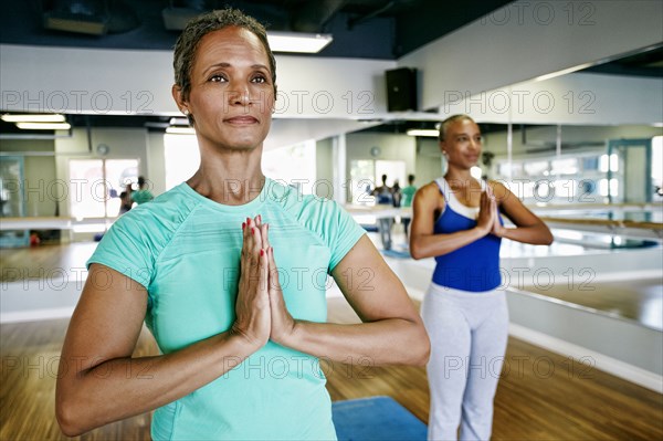 Women practicing yoga in studio