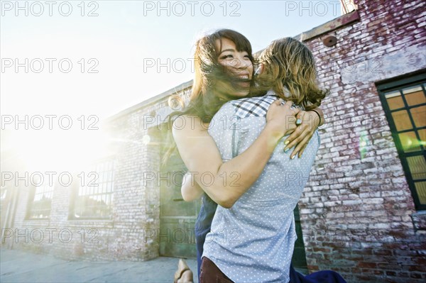 Couple hugging outdoors