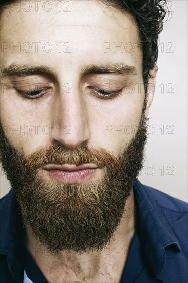 Caucasian man with beard looking down