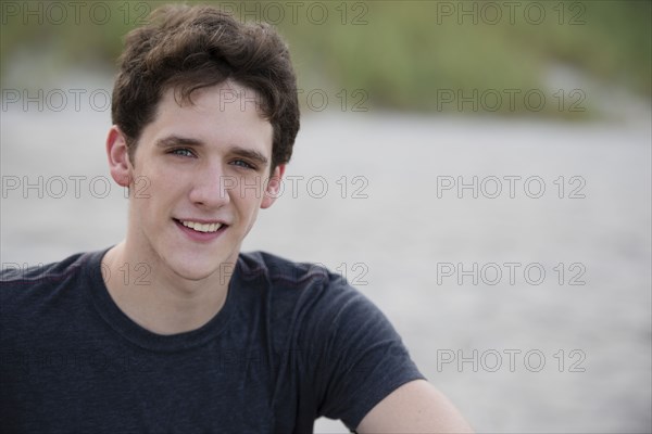 Hispanic man smiling on beach