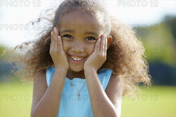 African American girl with hands on cheeks