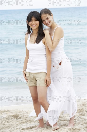 Women hugging on beach