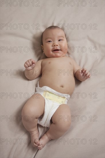 Chinese baby girl laying on bed