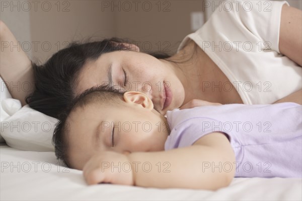 Chinese mother and baby sleeping