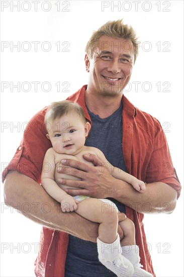 Smiling father holding baby