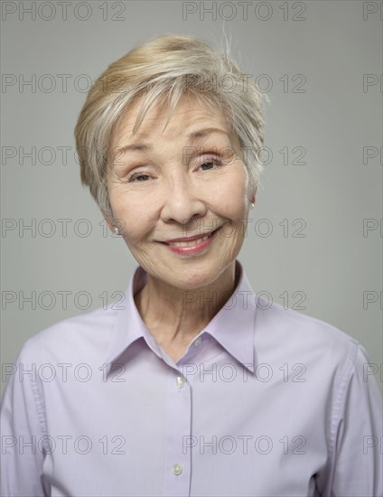 Close up of older Japanese woman smiling