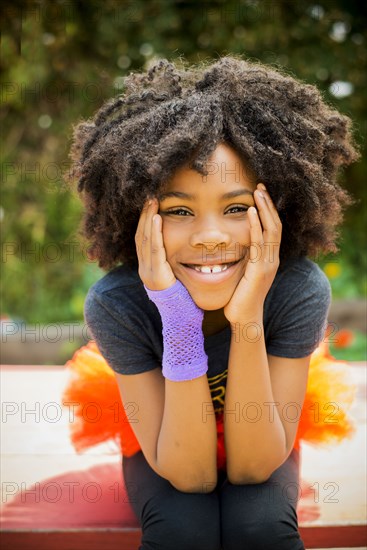 Close up of Black girl sitting on picnic table