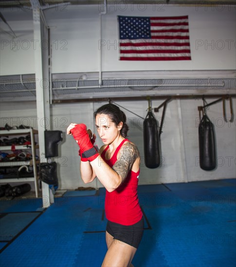 Caucasian boxer training in gymnasium