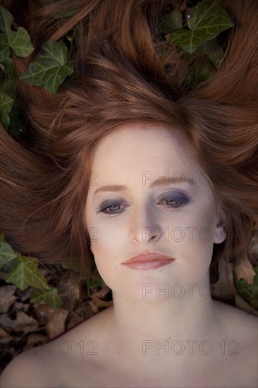 Close Up Of Serious Caucasian Woman Laying In Leaves Photo12 Tetra