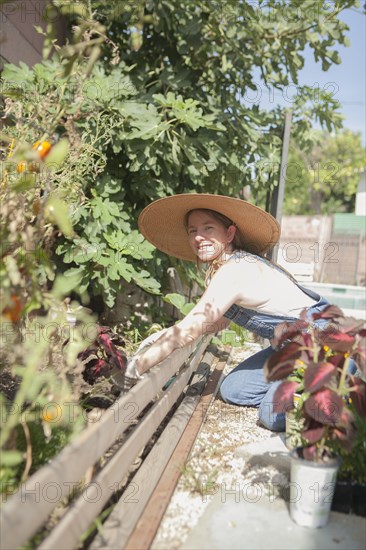 Mixed race farmer working in garden