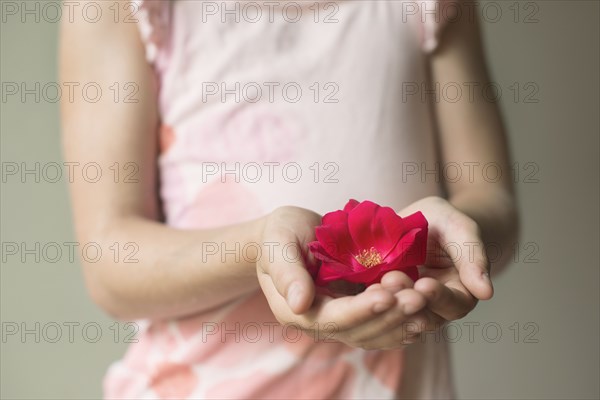 Caucasian girl holding blooming flower