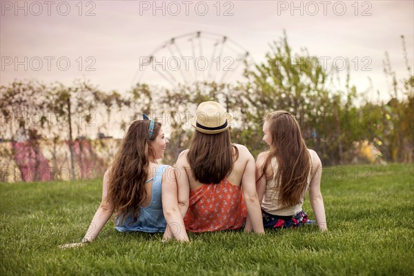 Caucasian women sitting in urban park
