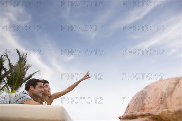 Hispanic couple relaxing outdoors