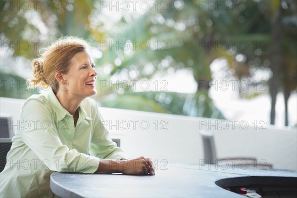 Woman sitting at patio bar