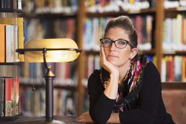 Librarian sitting at desk in library