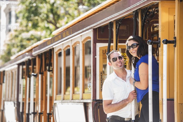 Hispanic couple riding cable car