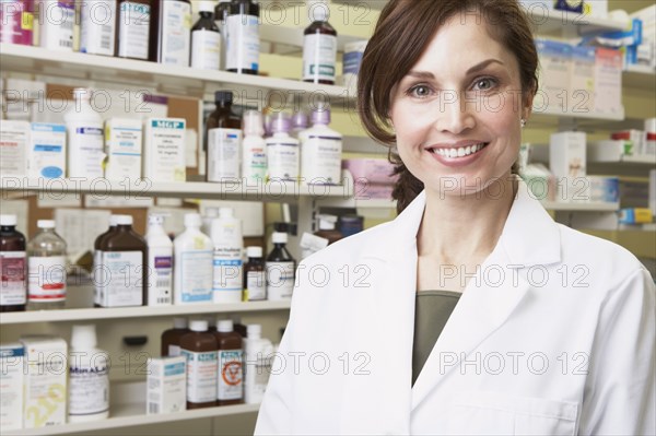 Female pharmacist smiling in pharmacy