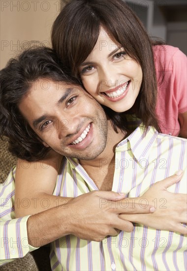 Close up of Hispanic couple hugging