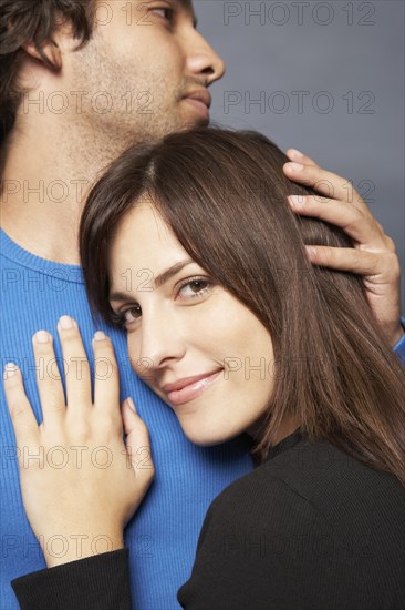 Close up of Hispanic couple hugging