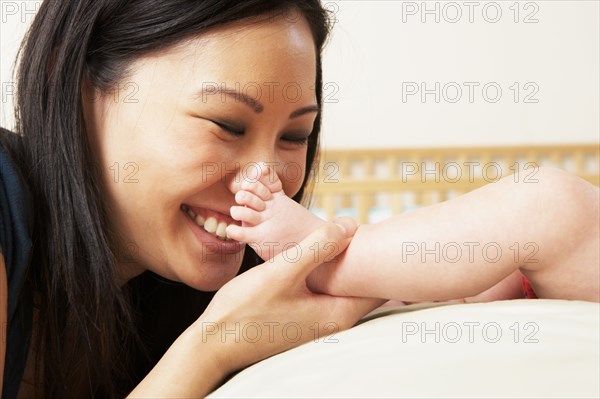 Mother kissing baby's feet