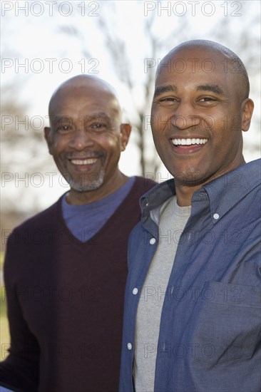 Portrait of African father and adult son