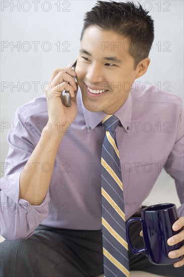 Asian businessman talking on cell phone