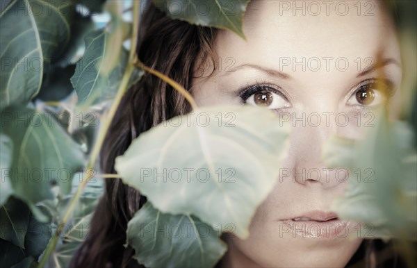 Native American Woman Peering Through Leaves Photo12 Tetra Images Trbfoto