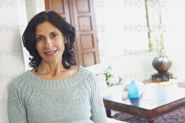 Confident Middle Eastern woman in living room