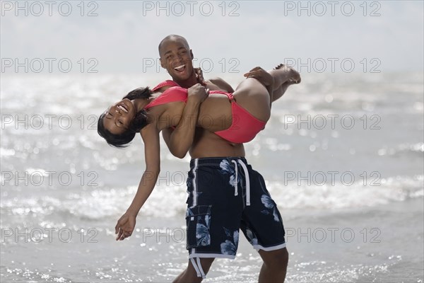 African man carrying girlfriend