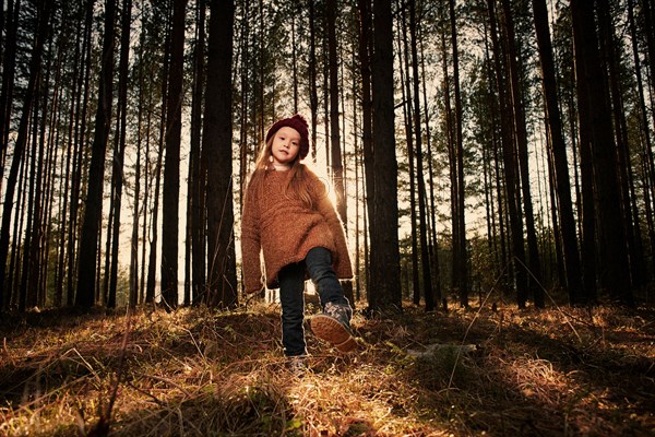 Caucasian girl playing in forest