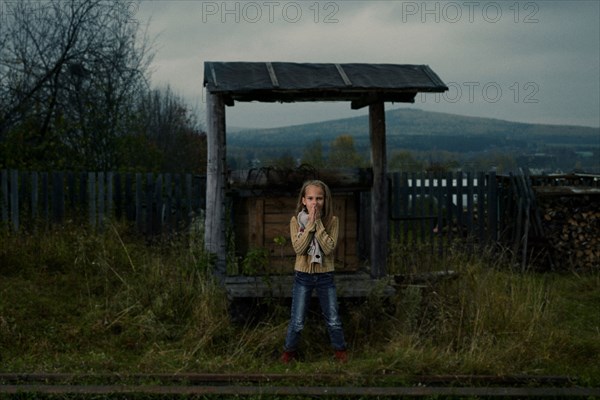 Caucasian girl waiting at rural train stop