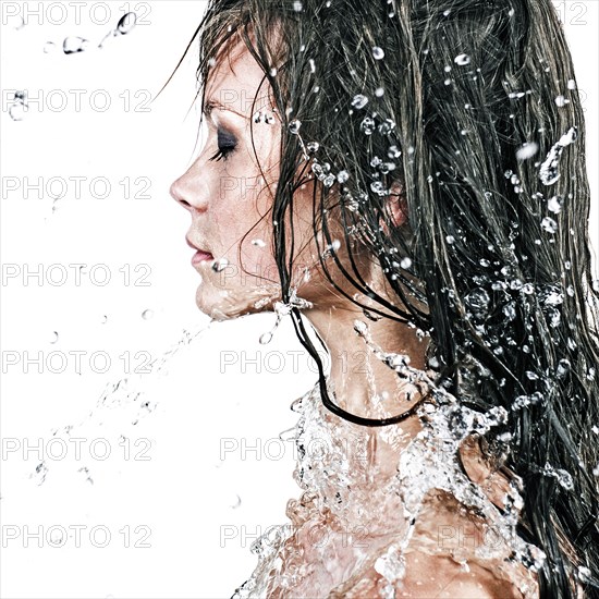 Face of Caucasian girl splashing in water