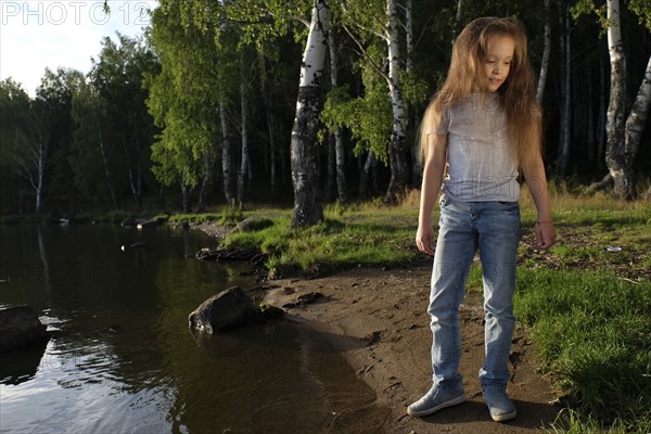 Caucasian girl standing near river