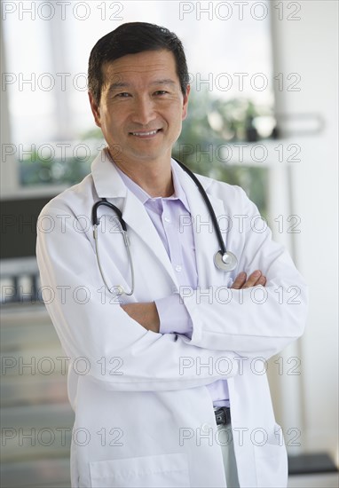 Smiling doctor with arms crossed