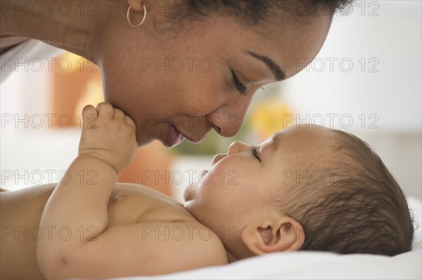 Mixed race mother talking to baby