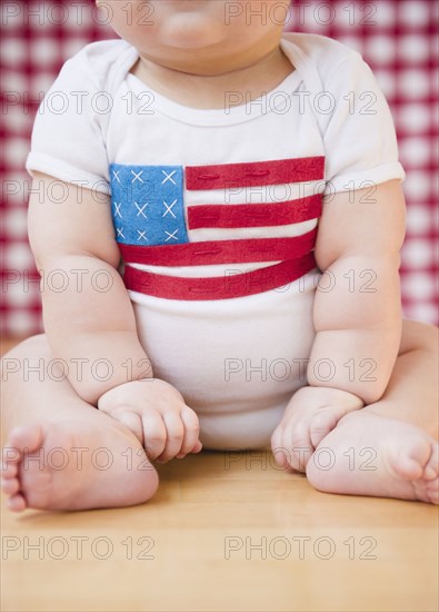 Caucasian baby boy in onesie with American flag on it