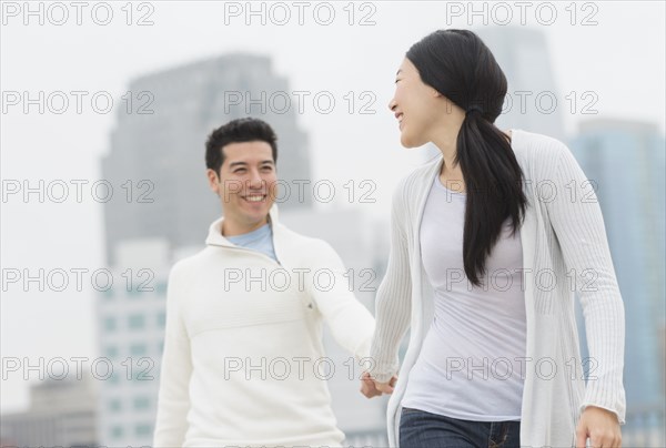 Couple holding hands in city