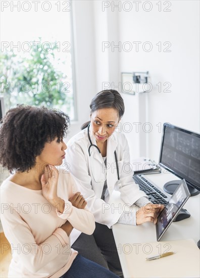 African American doctor and patient talking in office