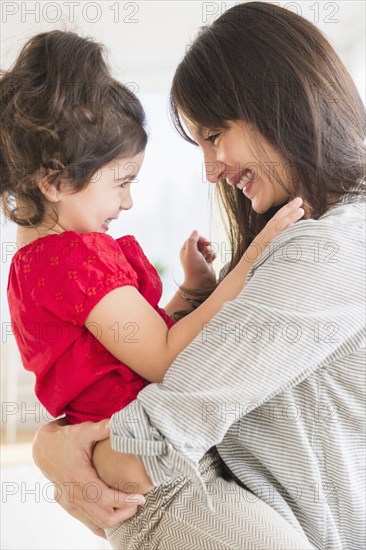 Hispanic mother and daughter playing together