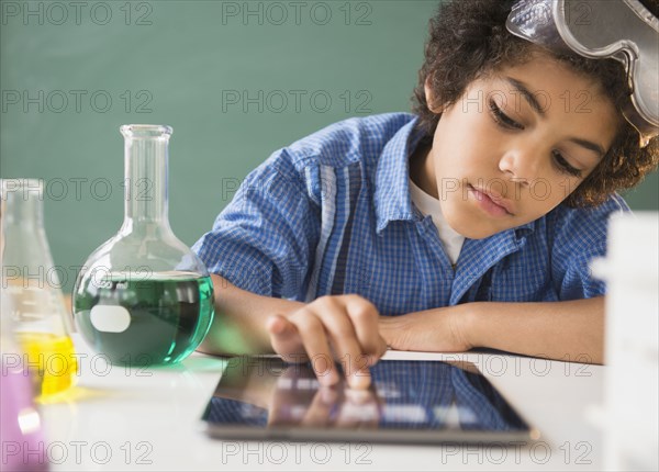 Mixed Race Boy Using Digital Tablet In Classroom Science Lab Photo12 7932