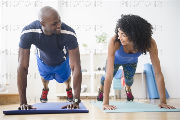 Couple doing push-ups in gym